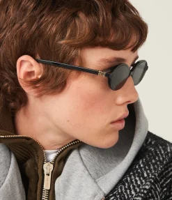 Miu Miu Oval Sunglasses in Black